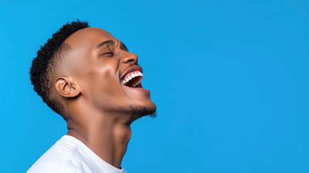 A vibrant portrait of a joyful African American male radiating positivity and confidence.の素材