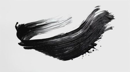 A bold Asian brush stroke in deep black ink isolated on a white background, showing expressive calligraphy.の素材