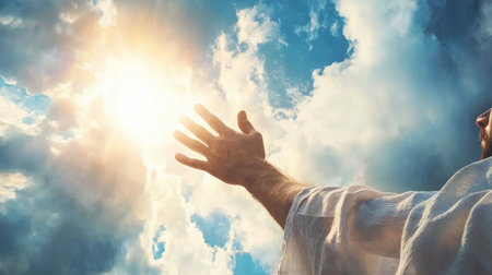 A hand reaching toward the heavens, symbolizing love, faith, and the promise of salvation in a divine, uplifting scene.の素材