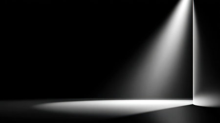 A stark minimalist interior featuring dark gray walls with a dramatic diagonal beam of natural light creating geometric shadows on the floor.の素材