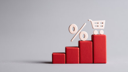 A conceptual image featuring red wooden blocks arranged in a rising bar graph, topped with a percentage sign and a shopping cart icon, symbolizing strong e-commerce sales growth, retail promotions, and online shopping success. This image is ideal for marketing, retail, and digital business presentations.の素材