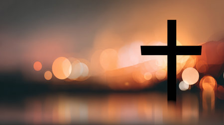 A powerful silhouette of a Christian cross stands against a vibrant, golden sunrise or sunset with beautiful bokeh lights, symbolizing hope, resurrection, and new beginnings. This image is perfect for Easter services, religious publications, inspirational social media posts, and church bulletinsの素材