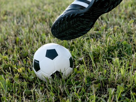 soccer player doing kick with ball on football stadium field. Football or soccer conceptの写真素材