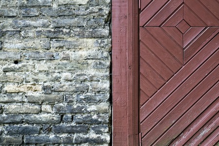 Fragment of old brick wall with a door. Texture background. Close up.の写真素材