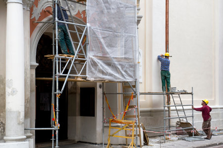 Restoration of the old building. Construction workers at work. Vilnius, Lithuania - June 20, 2016のeditorial素材