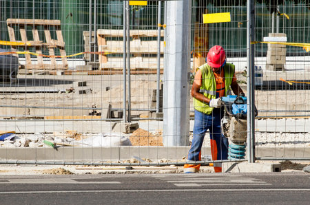 Builder worker at construction site. Completion of new office building in Konstitucijos prospect....