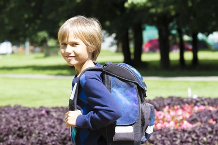 Child boy with a backpack go to school. Outdoor. Education, back to school, people concept.