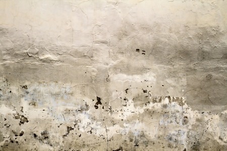 Cracked old plastered wall fragment background texture. Close upの写真素材