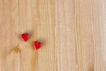 background with two wooden hearts, copy space for textの写真素材