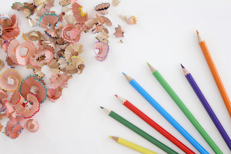 Colored pencils and shavings on white background with copy space. Top viewの写真素材