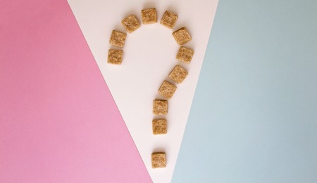 Brown sugar cubes shaped as a question mark. Top view. Diet unhealty sweet addiction diabetic conceptの写真素材
