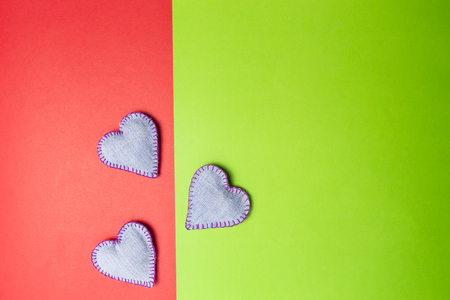 DIY handmade jeans hearts on colourful greenery and red background. Top view. Copy space for text.の写真素材