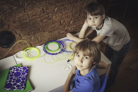 Children creating with 3D printing pen. One boy making new item. Creative, technology, leisure, education conceptの写真素材