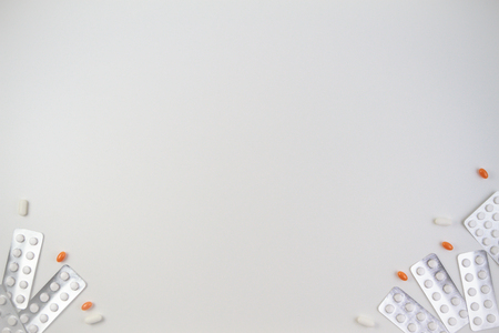 Medical tablets, capsules and pills in blister pack frame as background with copy space for text or imageの写真素材