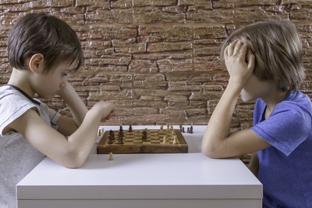 Kids playing chessの写真素材