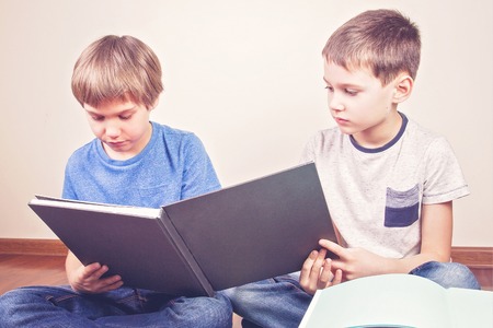 Kids reading books at homeの写真素材