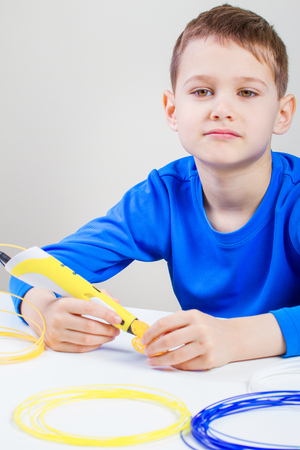 Child using 3D printing pen. Creative, technology, leisure, education concept