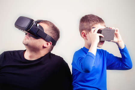 Man and kid using VR glassesの写真素材