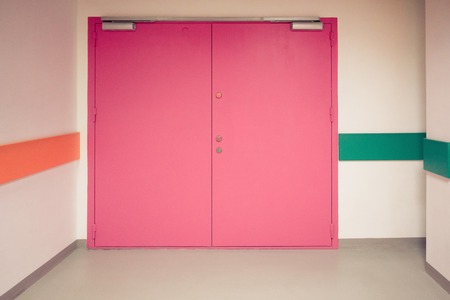 Closed colorful double doors along in the corridorの写真素材