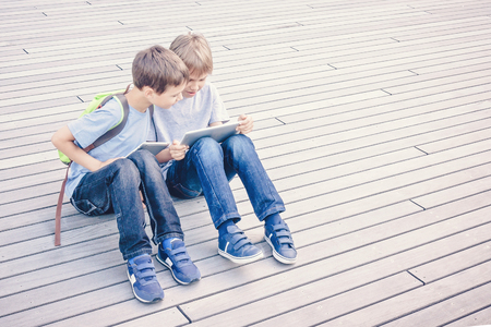 Children using tablet computers outdoor. People education learning technology leisure conceptの写真素材