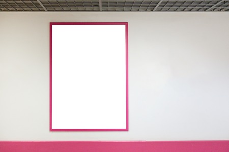 Mock up blank poster frame with pink frames hanging on wall in shopping millの写真素材