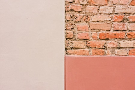 Old empty brick wall with painted plaster texture background.の写真素材