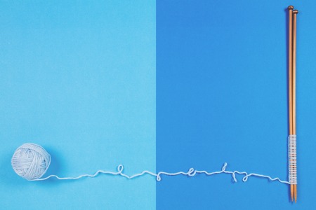 Blue yarn ball and knitting needles on colorful backgroundの写真素材