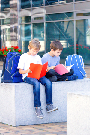 Children doing homework outdoors.の写真素材
