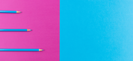 Blue pencils arranged on purple and blue contrast background.の写真素材