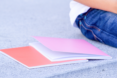 Books or notebook near sitting childの写真素材
