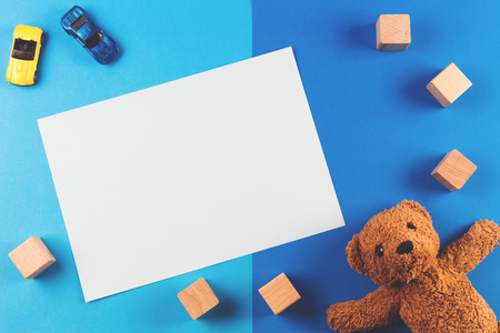 Kids toys background with teddy bear, cars and wooden blocksの写真素材
