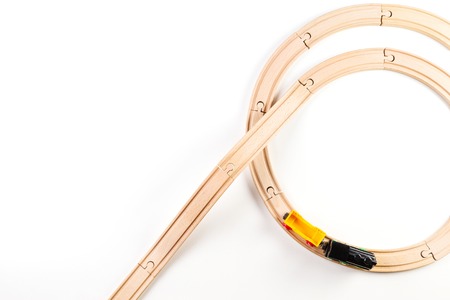 Toy train and wooden rails on white background. Top view.の写真素材