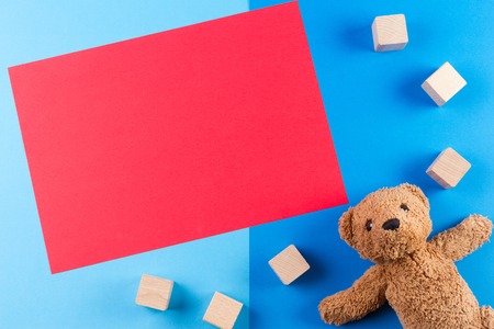 Kids toys background with teddy bear, cars and wooden blocksの写真素材