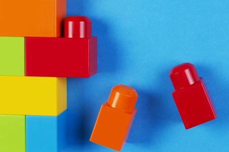 Colorful plastic construction blocks on blue backgroundの写真素材