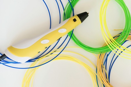 3D printing pen and filament on white backgroundの写真素材