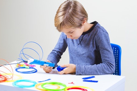 Boy creating with 3d printing penの写真素材