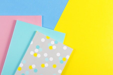 Colorful notebooks on blue and yellow backgroundの写真素材