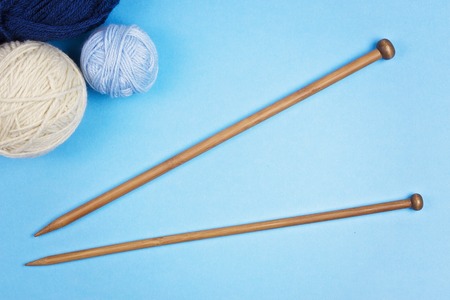 Knitting background. Knitting needles and balls of colorful yarn on white backgroundの写真素材