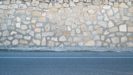 Stone wall and sidewalk road as backgroundの写真素材