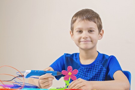 Child creating with 3d printing pen
