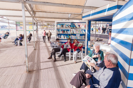 Benidorm, Spain - January 14, 2018: People resting, reading and playing chess in public Benidorm Levante Beach Library areaのeditorial素材