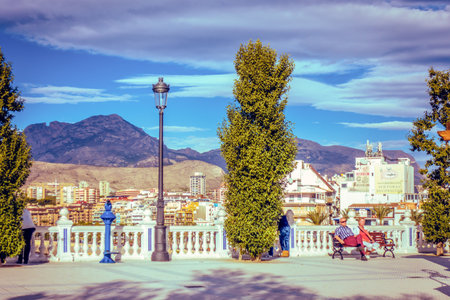 BENIDORM, SPAIN, DECEMBER 14, 2017: People relaxing on the bench in Mediterranean Balcony in Benidorm, Spainのeditorial素材
