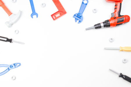 Toys construction tools border on white background. Top viewの写真素材