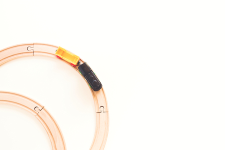 Toy train and wooden rails on white background. Top view.の写真素材
