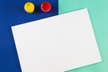 Blank paper sheet and watercolor paintsの写真素材