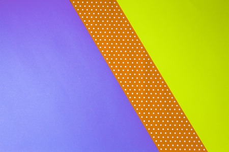 Abstract geometric yellow, purple and polka dot paper background.の写真素材
