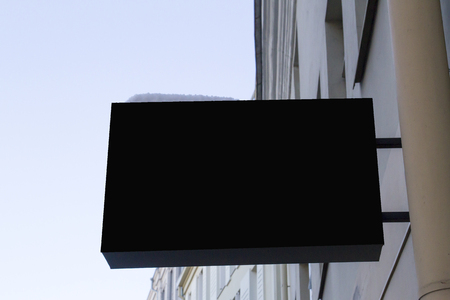 Black restangular signboard on the wall. Mock upの写真素材
