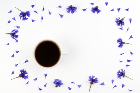 Cup of coffee with cornflowers frame. Top viewの写真素材