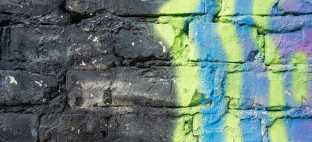 Fragment of colorful graffiti drawing on old brick wallの写真素材