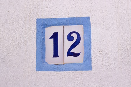House number on ceramic tiles on white wallの写真素材